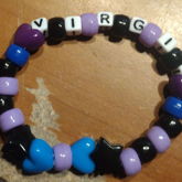 a purple blue and black bracelet with the name virgil 
      on it